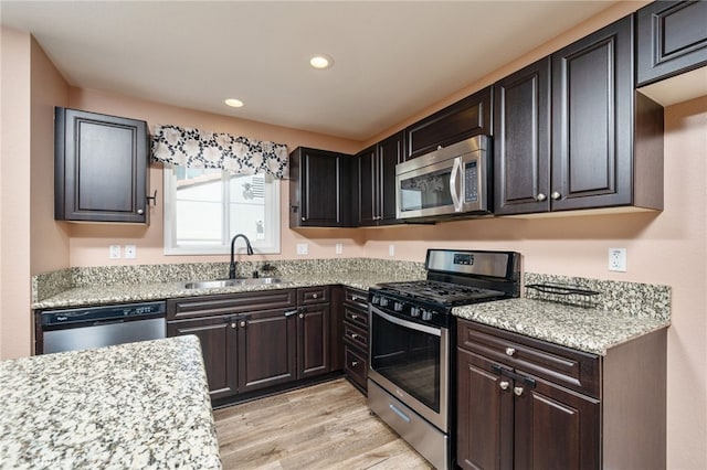 26649 Azalea St, Moreno Valley, CA 92555 - kitchen with appliances with stainless steel finishes, light wood-style floors, recessed lighting, and light stone counters