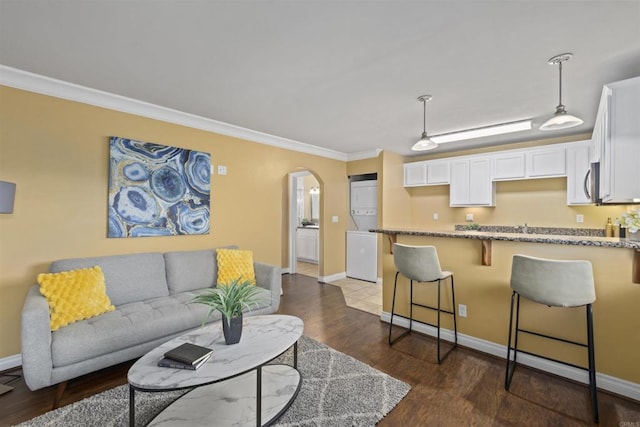 800 N Mollison Ave Unit 56, El Cajon, CA 92021 - living area featuring arched walkways, ornamental molding, and dark wood finished floors