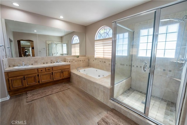 39560 Tinderbox Way, Murrieta, CA 92562 - full bathroom featuring wood finished floors, a stall shower, a whirlpool tub, double vanity, and recessed lighting