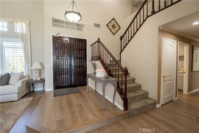 39560 Tinderbox Way, Murrieta, CA 92562 - entryway featuring wood finished floors, stairs, ornamental molding, and a high ceiling