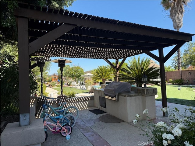 39560 Tinderbox Way, Murrieta, CA 92562 - view of patio / terrace featuring exterior kitchen, a putting area, and a pergola