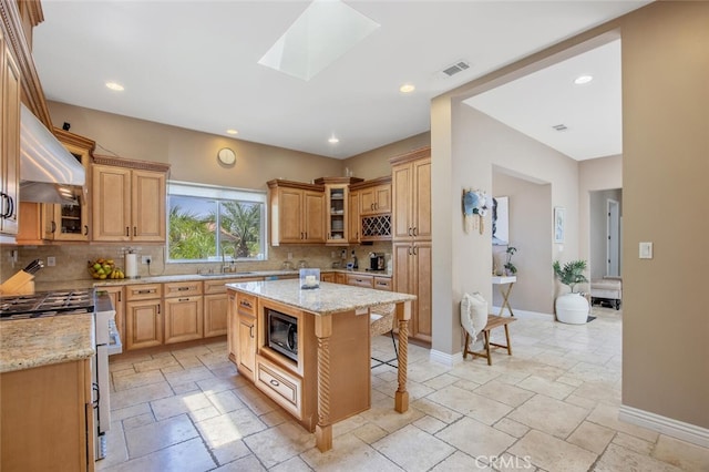 8817 Encino Ave, Sherwood Forest, CA 91325 - kitchen with gas stove, stone tile flooring, a breakfast bar area, backsplash, and custom exhaust hood