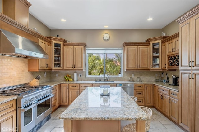 8817 Encino Ave, Sherwood Forest, CA 91325 - kitchen with appliances with stainless steel finishes, decorative backsplash, light stone counters, a center island, and recessed lighting