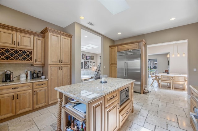 8817 Encino Ave, Sherwood Forest, CA 91325 - kitchen featuring built in refrigerator, stone tile flooring, decorative backsplash, recessed lighting, and light stone countertops