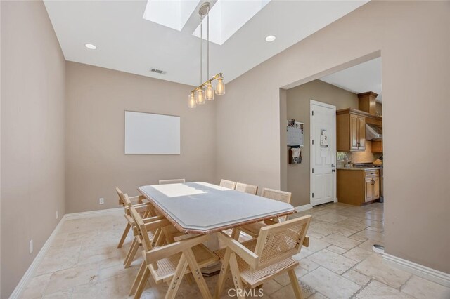 8817 Encino Ave, Sherwood Forest, CA 91325 - dining room with a skylight, stone tile floors, and recessed lighting