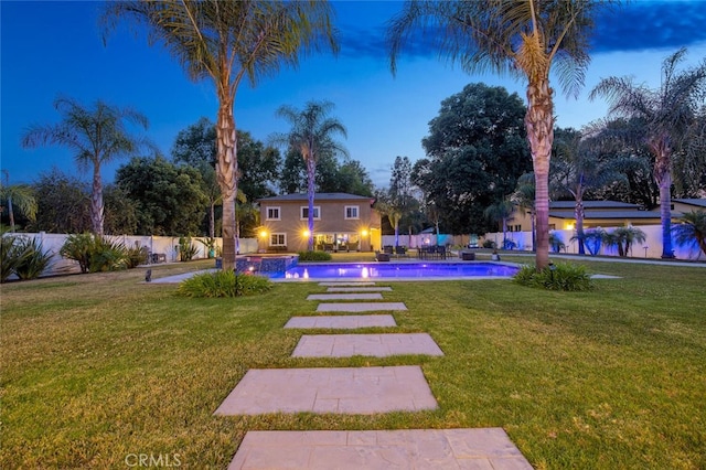 8817 Encino Ave, Sherwood Forest, CA 91325 - yard at dusk with a fenced backyard and a pool with connected hot tub