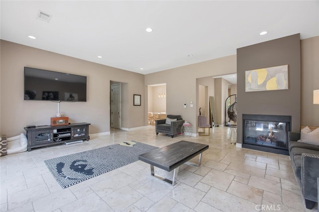 8817 Encino Ave, Sherwood Forest, CA 91325 - living room featuring recessed lighting, stone tile flooring, and a multi sided fireplace