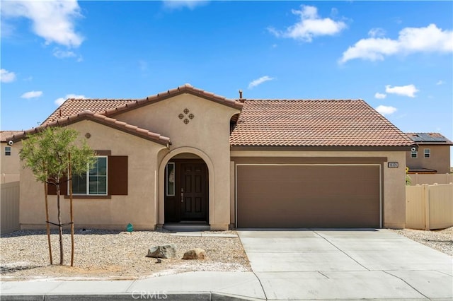 10335 Saint Andrews Ct, Adelanto, CA 92301 - mediterranean / spanish-style house featuring a garage, driveway, a tile roof, and stucco siding