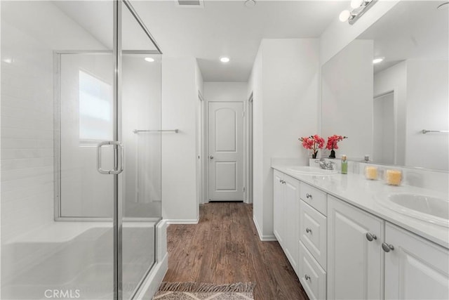 10335 Saint Andrews Ct, Adelanto, CA 92301 - bathroom with double vanity, a shower stall, and wood finished floors