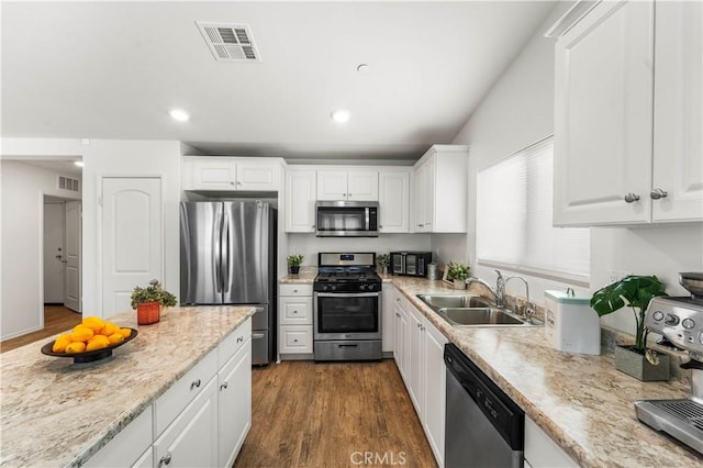 10335 Saint Andrews Ct, Adelanto, CA 92301 - kitchen with appliances with stainless steel finishes, white cabinets, dark wood-type flooring, recessed lighting, and light stone countertops