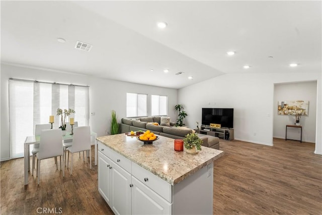 10335 Saint Andrews Ct, Adelanto, CA 92301 - kitchen with a kitchen island, lofted ceiling, dark wood finished floors, white cabinets, and recessed lighting