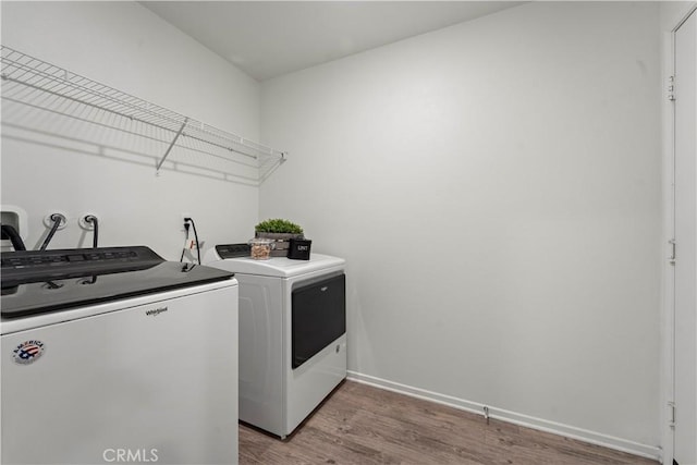 10335 Saint Andrews Ct, Adelanto, CA 92301 - washroom featuring independent washer and dryer and light wood-type flooring