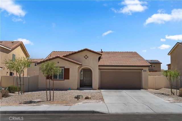 10335 Saint Andrews Ct, Adelanto, CA 92301 - mediterranean / spanish house with a garage, a tiled roof, stucco siding, and driveway