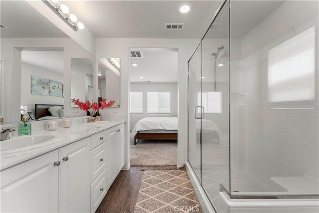 10335 Saint Andrews Ct, Adelanto, CA 92301 - ensuite bathroom with double vanity, a stall shower, wood finished floors, and recessed lighting
