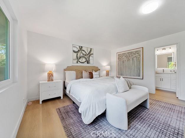 1050 Loma Verde Dr, Arcadia, CA 91006 - bedroom featuring light wood-type flooring, multiple windows, and ensuite bath