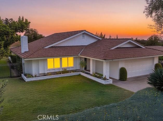 1050 Loma Verde Dr, Arcadia, CA 91006 - view of front facade with a chimney, a garage, and concrete driveway
