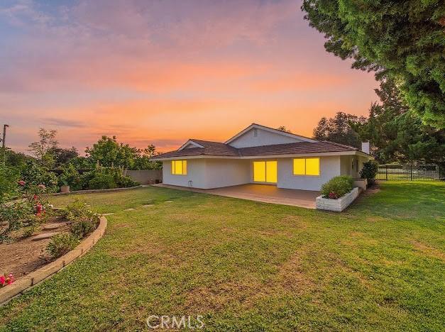 1050 Loma Verde Dr, Arcadia, CA 91006 - back of house at dusk featuring a patio
