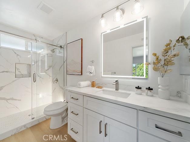 1050 Loma Verde Dr, Arcadia, CA 91006 - bathroom featuring a marble finish shower, vanity, and wood finished floors
