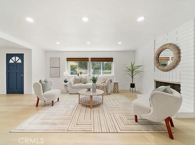1050 Loma Verde Dr, Arcadia, CA 91006 - living area with recessed lighting, wood finished floors, and a brick fireplace