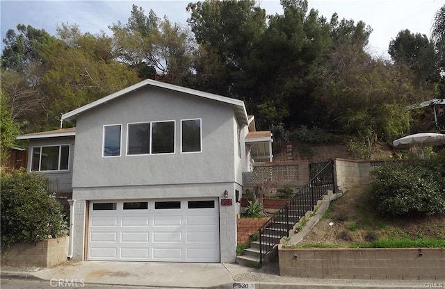 930 Mira Valle St, Monterey Park, CA 91754 - view of front of home featuring an attached garage, stairs, driveway, and stucco siding