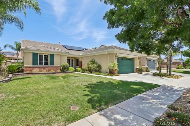 5136 Via Bajamar, Hemet, CA 92545 - single story home featuring stucco siding, a garage, solar panels, and a front yard