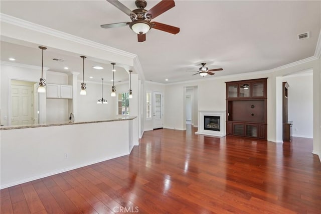 5136 Via Bajamar, Hemet, CA 92545 - unfurnished living room with a ceiling fan, wood finished floors, a glass covered fireplace, recessed lighting, and crown molding