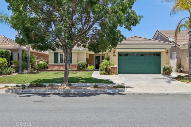 5136 Via Bajamar, Hemet, CA 92545 - view of front of property featuring a garage, stucco siding, driveway, and a front yard