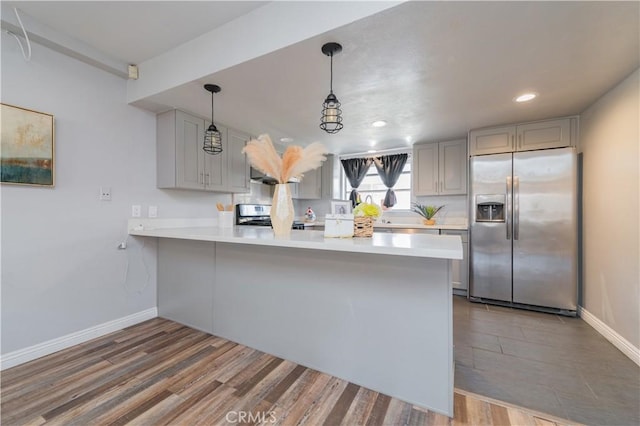 1223 S Golden W Ave Unit F, Arcadia, CA 91007 - kitchen with stainless steel fridge, stove, a peninsula, light countertops, and wood finished floors