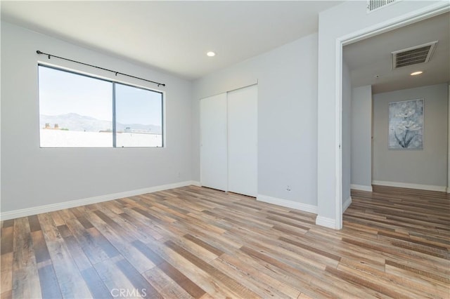 1223 S Golden W Ave Unit F, Arcadia, CA 91007 - unfurnished bedroom featuring light wood finished floors, a closet, and recessed lighting
