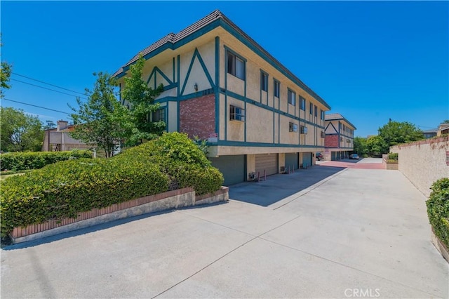 1223 S Golden W Ave Unit F, Arcadia, CA 91007 - view of building exterior featuring an attached garage and driveway
