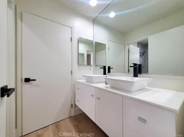 18134 Chase St, Northridge, CA 91325 - bathroom featuring double vanity and wood finished floors