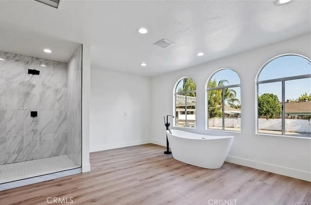 18134 Chase St, Northridge, CA 91325 - bathroom featuring a marble finish shower, recessed lighting, a freestanding tub, and wood finished floors