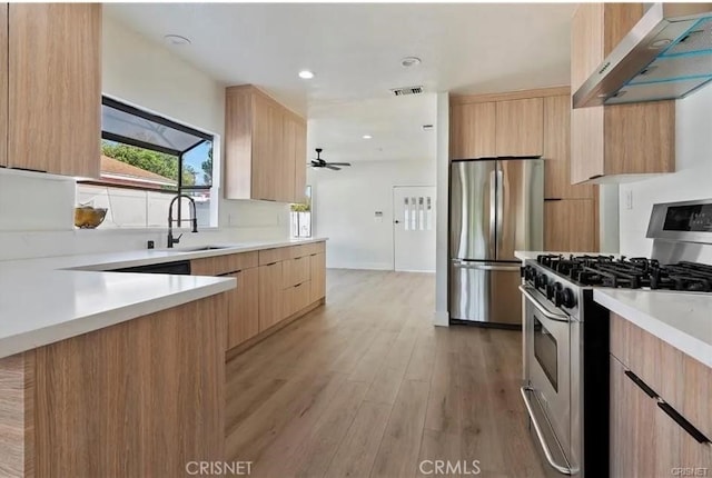 18134 Chase St, Northridge, CA 91325 - kitchen featuring stainless steel appliances, extractor fan, modern cabinets, light countertops, and recessed lighting