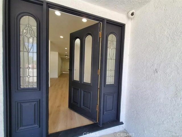18134 Chase St, Northridge, CA 91325 - doorway to property with stucco siding and a security system