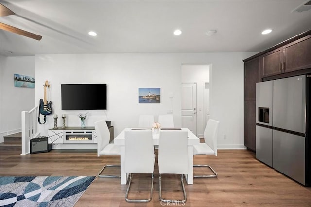 1742 Heywood St Unit C, Simi Valley, CA 93065 - dining area featuring light wood finished floors, ceiling fan, recessed lighting, and stairs