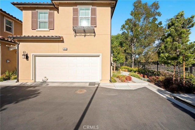 1742 Heywood St Unit C, Simi Valley, CA 93065 - view of front facade featuring an attached garage, stucco siding, and asphalt driveway