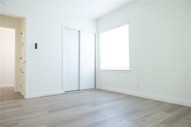 4622 Sunnyside Dr, Riverside, CA 92506 - unfurnished bedroom featuring light wood-style floors and a closet