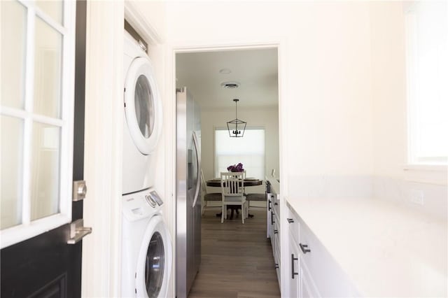 4622 Sunnyside Dr, Riverside, CA 92506 - laundry room with stacked washer and clothes dryer and wood finished floors