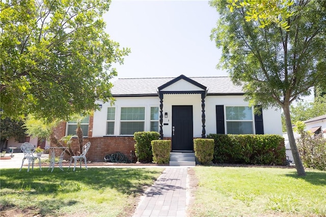 4622 Sunnyside Dr, Riverside, CA 92506 - bungalow-style home with a front yard, brick siding, stucco siding, and a shingled roof