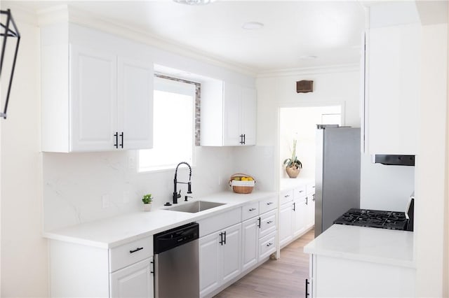 4622 Sunnyside Dr, Riverside, CA 92506 - kitchen with appliances with stainless steel finishes, white cabinets, decorative backsplash, light wood-style floors, and crown molding