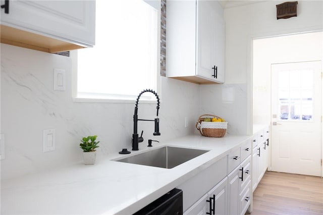 4622 Sunnyside Dr, Riverside, CA 92506 - kitchen featuring plenty of natural light, white cabinetry, light countertops, and light wood-style floors