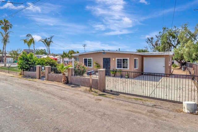 133 Lotus Dr, Chula Vista, CA 91911 - view of front of property featuring an attached garage, a fenced front yard, driveway, and stucco siding