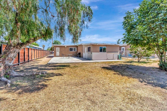 133 Lotus Dr, Chula Vista, CA 91911 - rear view of house featuring a patio, a fenced backyard, and stucco siding