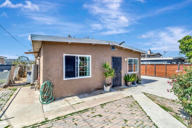 133 Lotus Dr, Chula Vista, CA 91911 - back of property with stucco siding, a patio area, and gas water heater