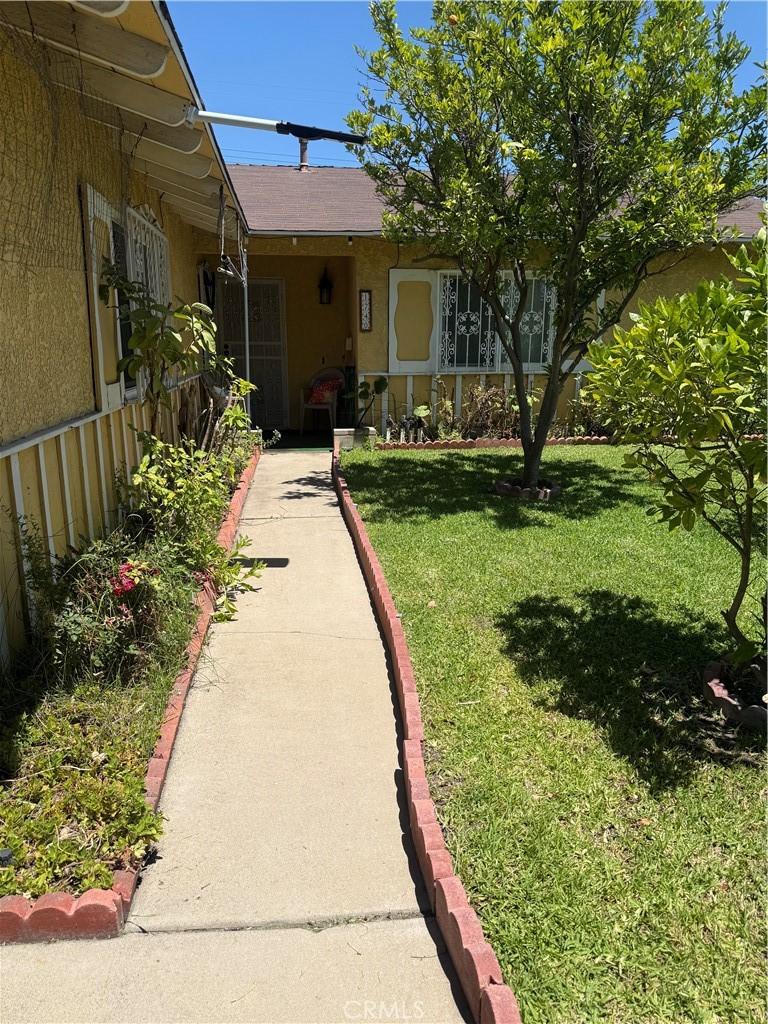 1740 N Del Norte Ave, Ontario, CA 91764 - entrance to property with a yard and stucco siding