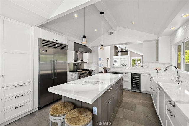 1119 Grove Ln, Newport Beach, CA 92660 - kitchen with premium appliances, beverage cooler, light stone countertops, wall chimney exhaust hood, and recessed lighting
