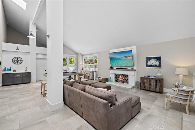 1119 Grove Ln, Newport Beach, CA 92660 - living room featuring a warm lit fireplace, bar area, and high vaulted ceiling