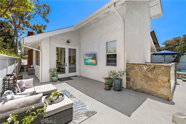 1119 Grove Ln, Newport Beach, CA 92660 - rear view of house featuring french doors, a patio, stucco siding, an outdoor living space, and a chimney