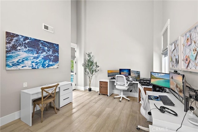 1119 Grove Ln, Newport Beach, CA 92660 - home office featuring a towering ceiling, light wood-type flooring, and plenty of natural light