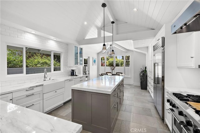 1119 Grove Ln, Newport Beach, CA 92660 - kitchen featuring wall chimney exhaust hood, a center island, light stone counters, white cabinets, and high quality appliances